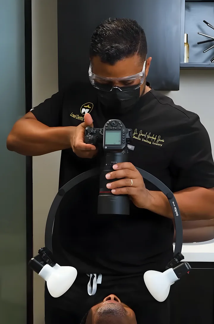Dr. Daniel photographs a patient’s smile to design it