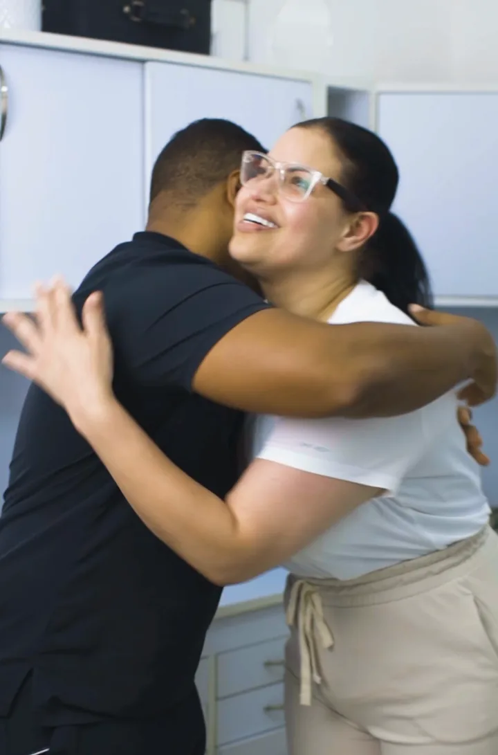 A patient hugs Dr. Daniel